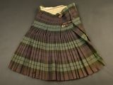 a close up of a plaid skirt with buttons on it