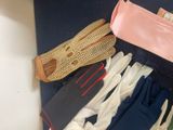 many pairs of gloves and gloves laid out on the floor