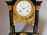 a black and gold clock with a gold star on it