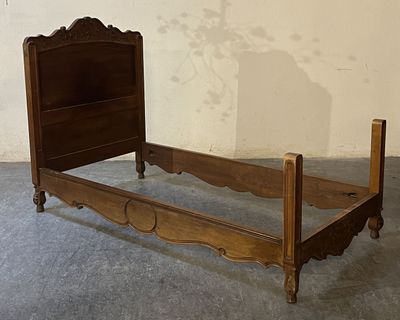 a bed with a wooden headboard and foot board