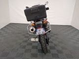 a motorcycle that is parked in a room with a checkered floor