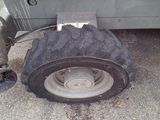 a tire that is sitting on the ground next to a truck
