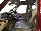 the interior of a red car with a steering wheel and dashboard