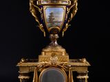 a gold and blue vase sitting on top of a table