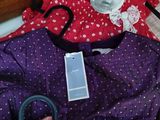 a pile of clothes that is sitting on a bed