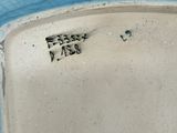 a blue and white plate that has a black and white design on it