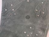 a close up of a pillow with a flower design on it
