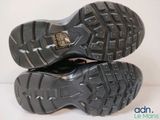the soles of a pair of black shoes on a white surface