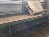 a pile of paper sitting on top of a workbench