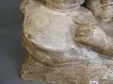 a statue of a woman holding a baby on her lap