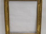 a gold picture frame with a white background