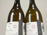 two bottles of wine sitting next to each other on a table