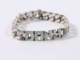 a close up of a silver bracelet with a chain on it
