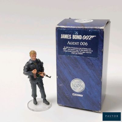 a figurine of a man holding a gun in front of a box of james bond 002 agent 006