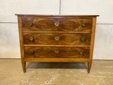 an image of a wooden chest of drawers in a room