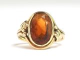 une image représentant une bague en or sertie d'une pierre orange
