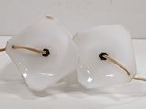 pair of white glass lamps with gold wire on a white surface