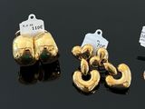 several different types of gold jewelry are displayed on a black surface