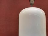 a lamp that is sitting on a table next to a red wall