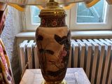 a lamp that is sitting on a table in front of a radiator