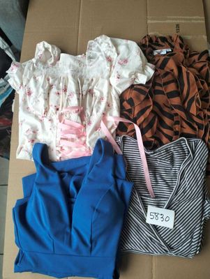 a cardboard box with a lot of clothes on it