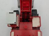 a red toy truck that is sitting on a white surface