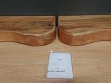 two pieces of wood sitting on top of a table next to each other