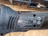 a black and silver electric tool sitting on a table