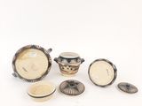 several pieces of pottery sitting on top of a table next to each other