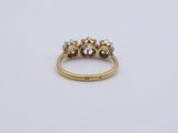 an image of a gold ring with three diamonds on it