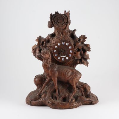 an image of a wooden clock with a deer and a bird on it