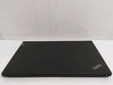 the back of a black laptop computer sitting on top of a white table