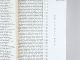 an open book with a page in it on a table