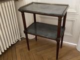 a small table with a shelf on it in the corner of a room