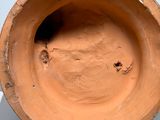 a clay bowl sitting on top of a table