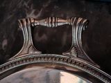 a large silver plate with a handle on it