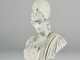 a white marble bust of a woman with a bird on her head