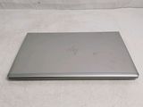 a laptop that is sitting on a white surface
