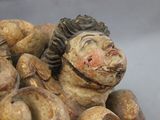 a figurine of a man laying on top of a pile of doughnuts