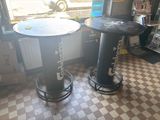 a table and two stools in a room with a checkered floor