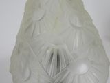 a glass lamp that is on a stand on a table