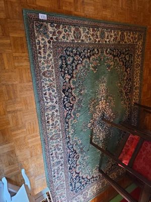 a chair and a rug in the corner of a room