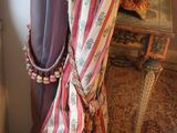 a curtain that is hanging on the side of a table
