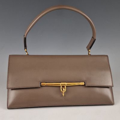 an image of a brown leather handbag with a gold handle