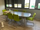 a table and chairs in a room with a large window