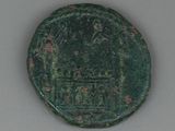 an image of a green coin with a design on it