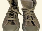 a pair of shoes that are on a white surface