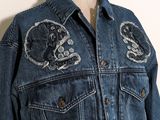 an image of a denim jacket with patches on it