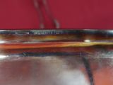 a silver plate with a handle on a red background