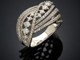 a close up of a diamond ring on a black surface